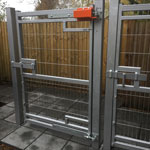 Front view industrial version Mk7 Left side anti lift fitted to a metal gate covering extended field gate hook on plate on a metal post gate in closed position